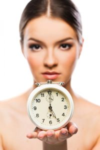 Woman Holding Clock