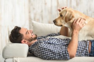 man resting with his dog at home-img-blog